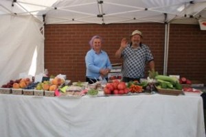 Lyuba and her husband tending their booth at the market